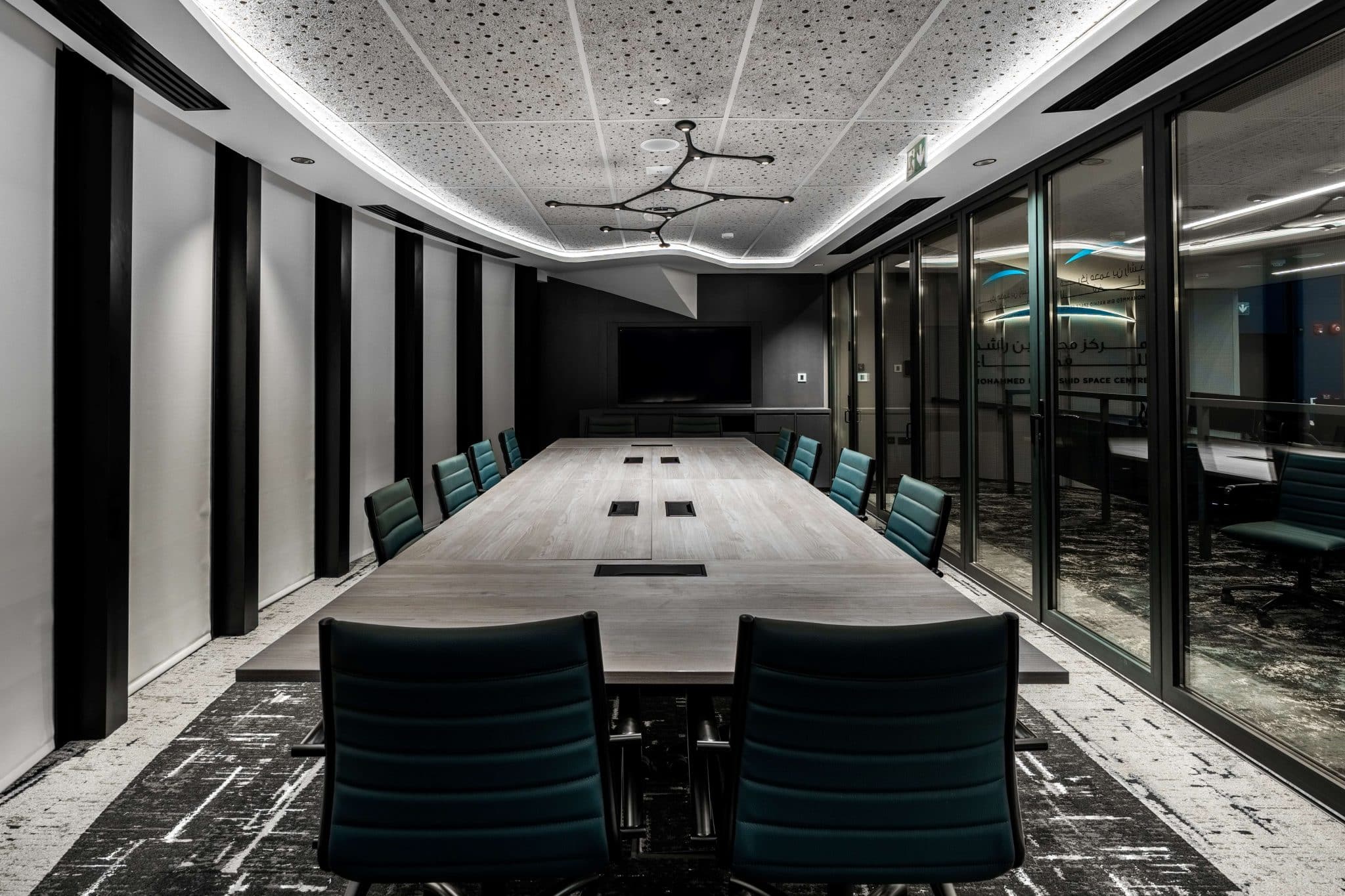 Meeting room with integrated ceiling and perimeter lighting at MBRSC